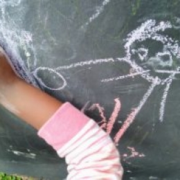 Drawing on the blackboard during free play at Constantia Montessori