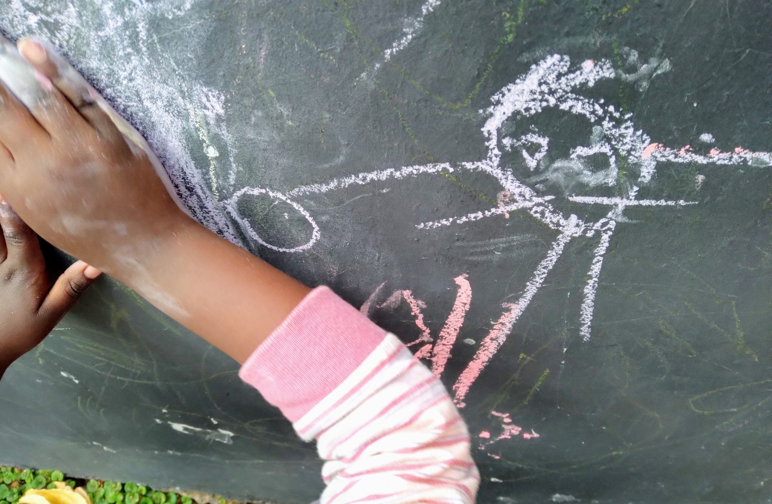 Drawing on the blackboard during free play at Constantia Montessori